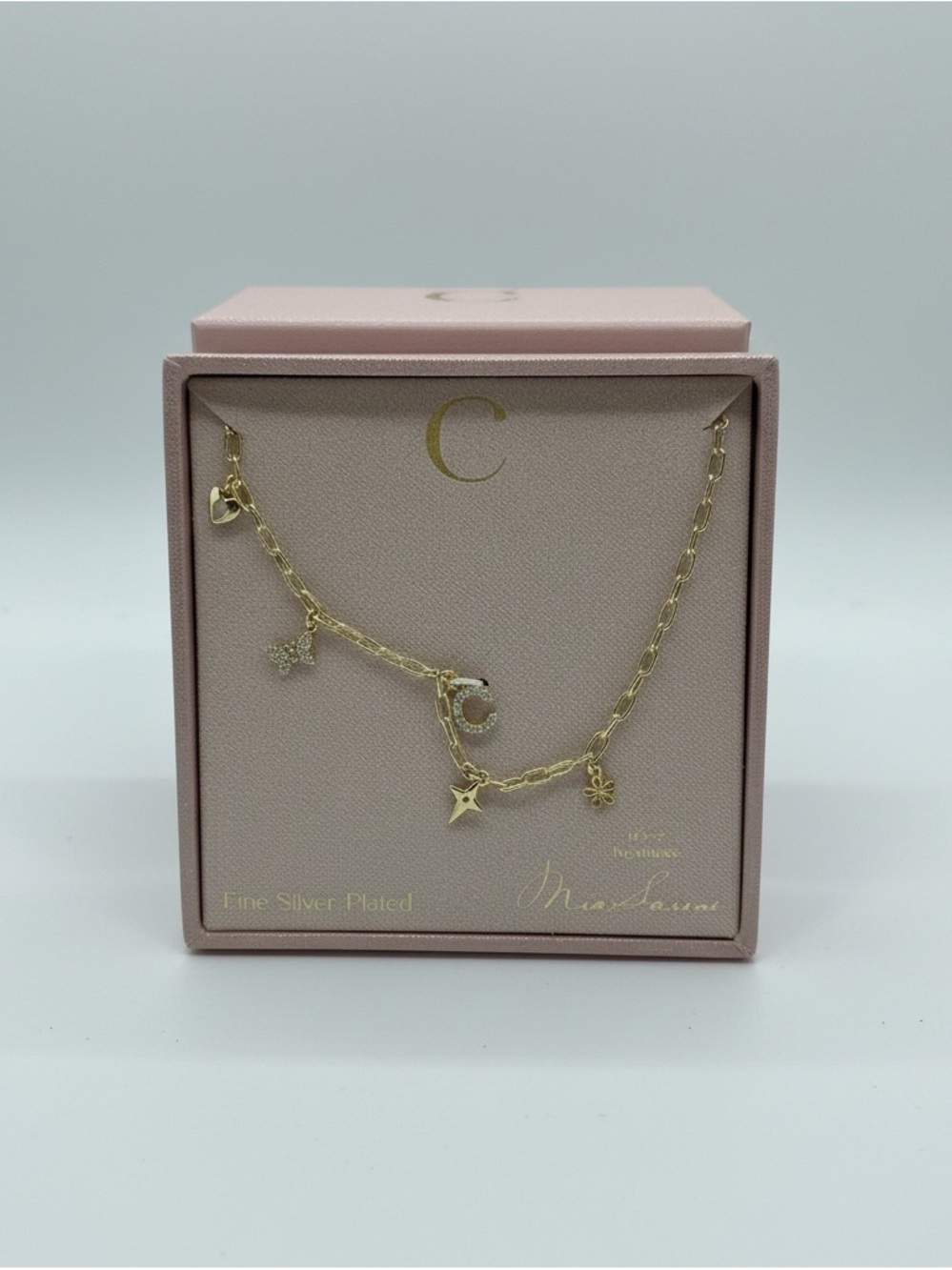 Fine plated necklace with C initial and cuties charm.